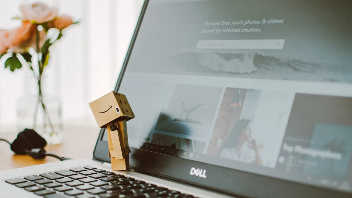 AI for Amazon affiliate content — The Complete Guide — Amazon Box Looking at Black Dell Laptop