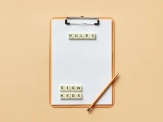Clipboard with rules and sign here labels