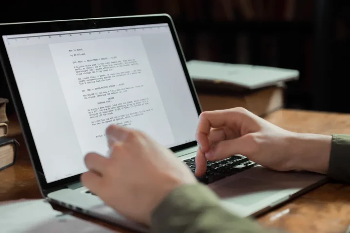 hands typing a document on a laptop