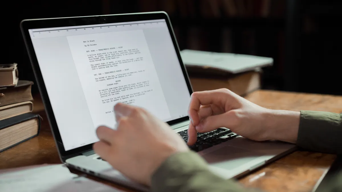 hands typing a document on a laptop