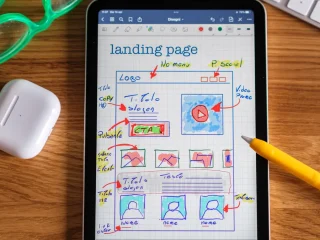 Tablet with sketched website landing page wireframe