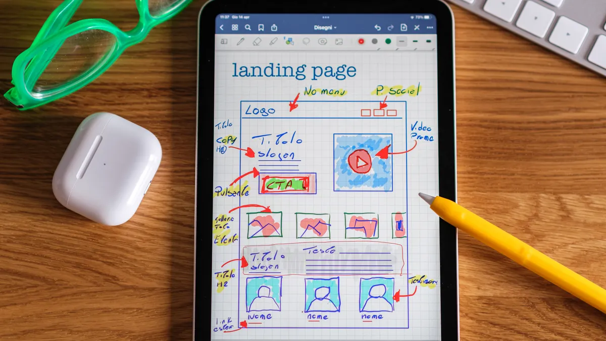 Tablet with sketched website landing page wireframe