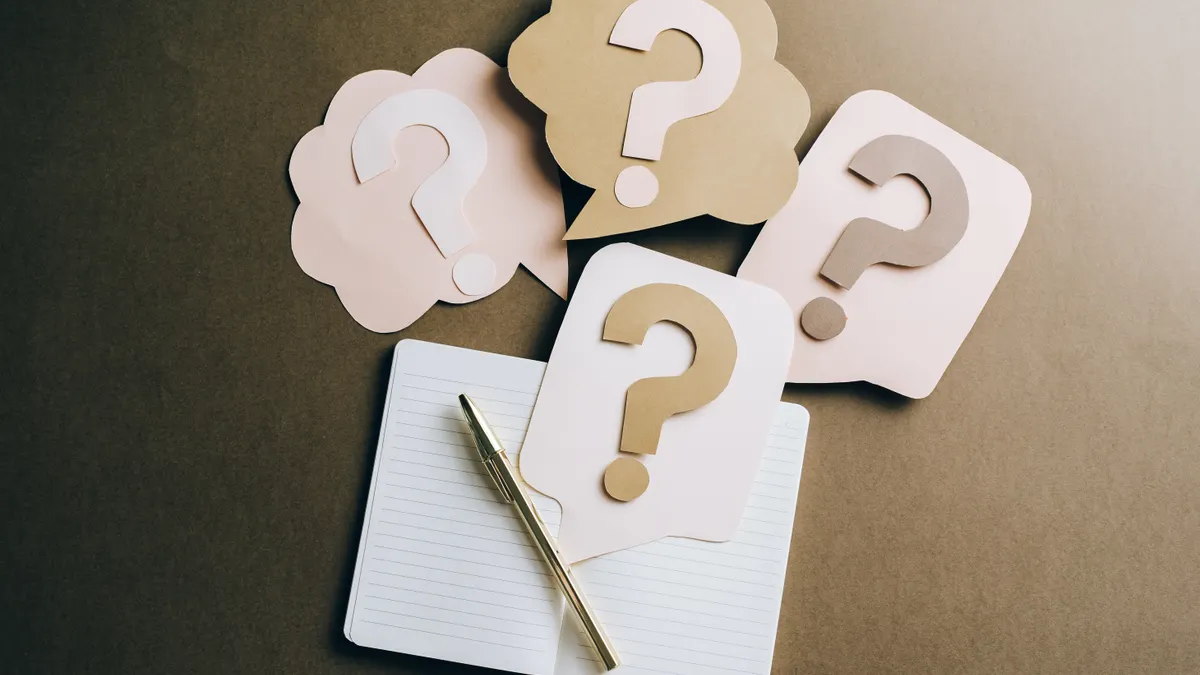 Question-mark cards on a notebook
