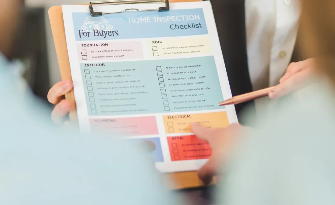 Hand holding a buyer's checklist clipboard