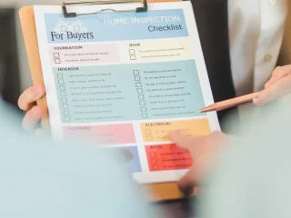 Hand holding a buyer's checklist clipboard