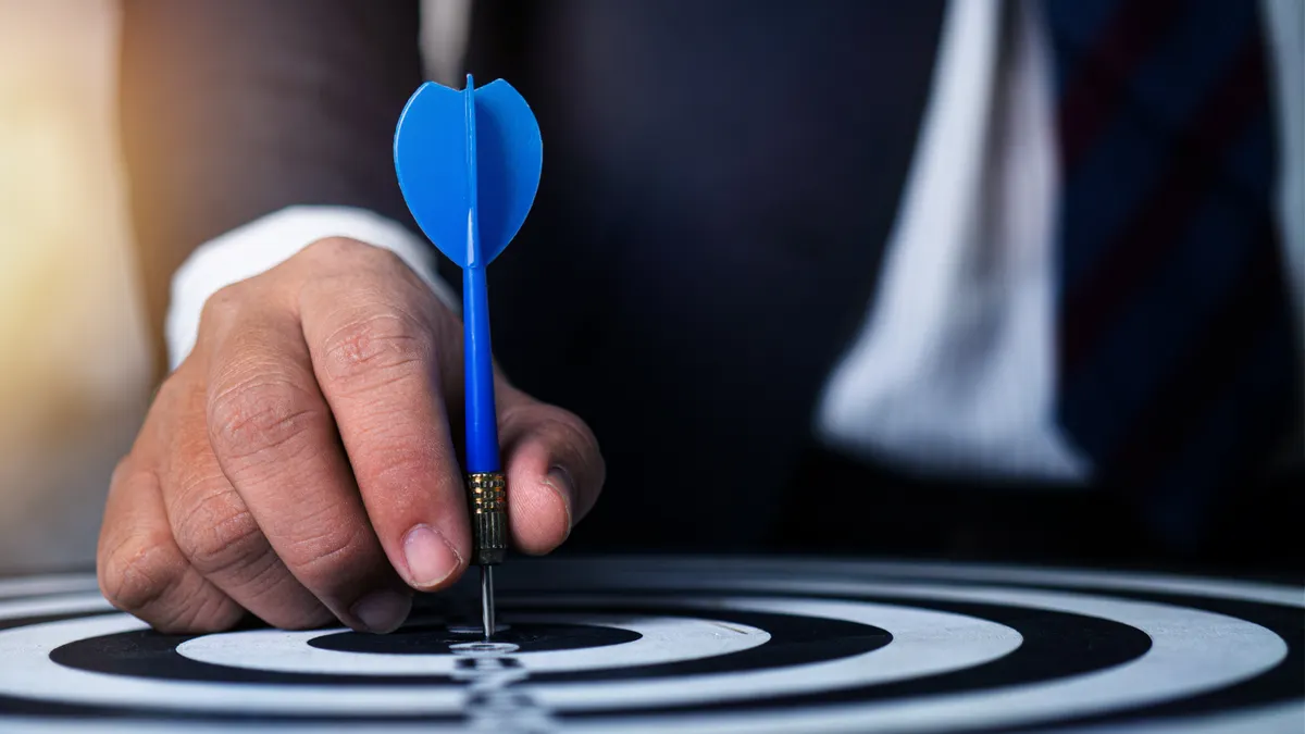 dart hitting the center of a target