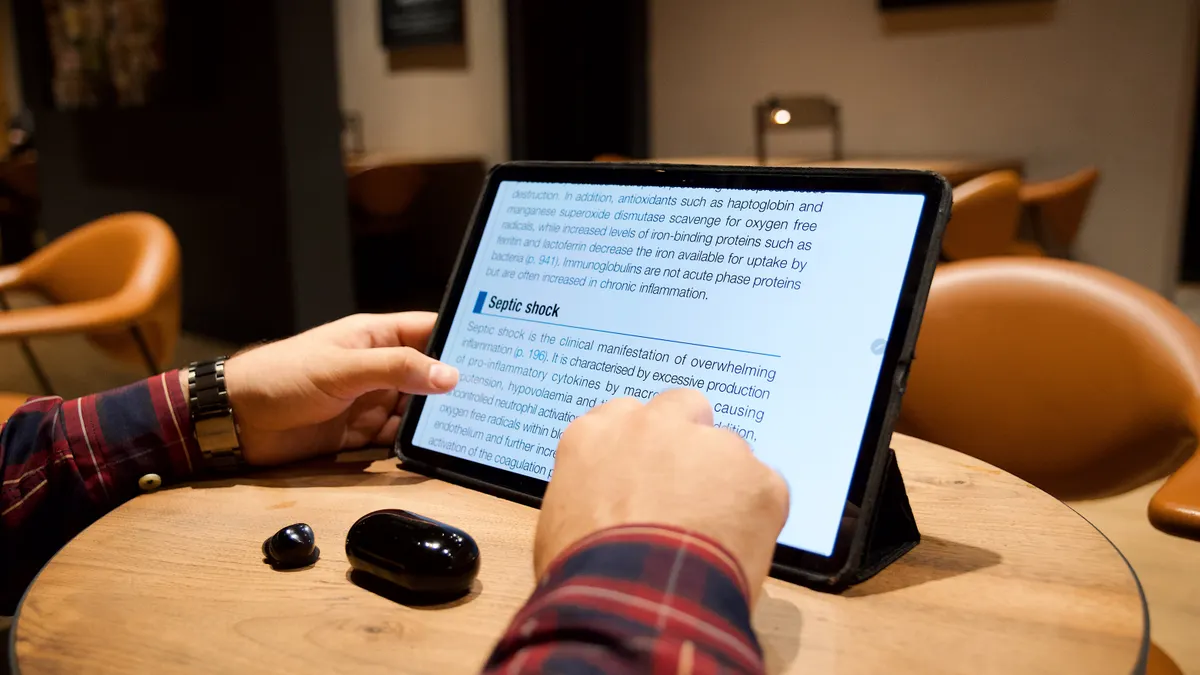 person reading a draft on a tablet